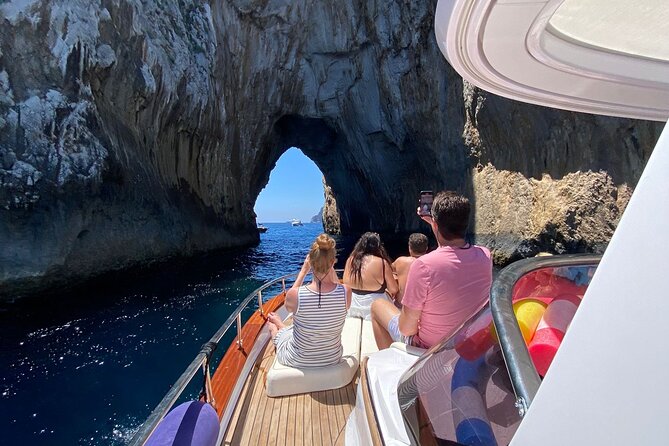 From Positano : Elite Capri Boat Day Free Bar, Brunch & City Walk - The early coastal sights: Spiaggia Grande and Bagni di Tiberio